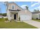 Inviting two-story home with neutral siding, a black front door, and an attached two-car garage at 787 Dusty Pine Way, Myrtle Beach, SC 29588