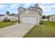 Attached garage and driveway, complemented by a well-manicured lawn, on a sunny day at 787 Dusty Pine Way, Myrtle Beach, SC 29588