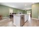 Bright, open kitchen featuring an island with granite countertops, stainless steel appliances, and hardwood floors at 787 Dusty Pine Way, Myrtle Beach, SC 29588