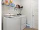 Efficient laundry room featuring modern washer and dryer units, storage shelves, and tile floor at 787 Dusty Pine Way, Myrtle Beach, SC 29588
