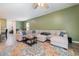 Spacious living room featuring a sectional sofa, colorful rug, and open access to the dining and kitchen areas at 787 Dusty Pine Way, Myrtle Beach, SC 29588