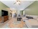 Inviting living room showcases a sectional sofa, vibrant rug, and seamless flow to the modern kitchen at 787 Dusty Pine Way, Myrtle Beach, SC 29588