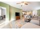 Open concept living area flows into the kitchen with a sectional sofa, rug, and entertainment center at 787 Dusty Pine Way, Myrtle Beach, SC 29588