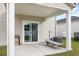Covered patio with outdoor seating, a sliding glass door, and backyard views, great for relaxing at 787 Dusty Pine Way, Myrtle Beach, SC 29588