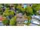 Aerial view of a neighborhood featuring multiple homes, driveways, swimming pools, and mature trees at 8 Martinique Dr., Myrtle Beach, SC 29572
