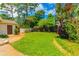 Lush backyard with green grass, mature trees, and tropical foliage at 8 Martinique Dr., Myrtle Beach, SC 29572
