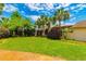 Expansive backyard features lush green grass, mature palm trees and well-maintained landscaping at 8 Martinique Dr., Myrtle Beach, SC 29572