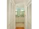 Hallway view of an elegant bathroom featuring double sinks and stylish neutral decor at 8 Martinique Dr., Myrtle Beach, SC 29572