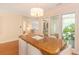 Dining area featuring a unique light fixture, hardwood floors, and views into the living spaces at 8 Martinique Dr., Myrtle Beach, SC 29572