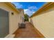 Exterior walkway showcasing stucco walls, brick pavers, and an efficient air conditioning system at 8 Martinique Dr., Myrtle Beach, SC 29572