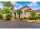 Charming home featuring a stucco exterior, red tile roof, well-manicured landscaping, and inviting front gate at 8 Martinique Dr., Myrtle Beach, SC 29572