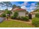 Charming home exterior with lush greenery, a tiled roof, and a private gated entrance at 8 Martinique Dr., Myrtle Beach, SC 29572