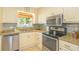Kitchen features stainless steel appliances, granite countertops, mosaic backsplash, and bright natural light at 8 Martinique Dr., Myrtle Beach, SC 29572