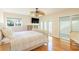 Bright main bedroom featuring hardwood floors, a ceiling fan, and access to a private outdoor area at 8 Martinique Dr., Myrtle Beach, SC 29572