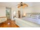 Serene main bedroom showcasing hardwood floors, a ceiling fan, and ensuite access at 8 Martinique Dr., Myrtle Beach, SC 29572