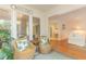 Cozy sunroom with wicker furniture and a bright view leading to other rooms at 8 Martinique Dr., Myrtle Beach, SC 29572