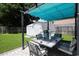 Inviting backyard featuring a pergola, an outdoor dining set, shed, and green lawn at 867 Cardinal Pl., North Myrtle Beach, SC 29582