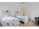 Bright bedroom featuring two beds, hardwood floors and a ceiling fan at 867 Cardinal Pl., North Myrtle Beach, SC 29582