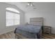 Bright bedroom featuring a vaulted ceiling, a large arched window, and modern furnishings at 867 Cardinal Pl., North Myrtle Beach, SC 29582