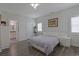 Bright bedroom featuring hardwood floors, a ceiling fan, a modern bed frame and an adjacent bathroom at 867 Cardinal Pl., North Myrtle Beach, SC 29582