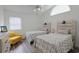 Bright bedroom featuring two beds, vaulted ceilings, and a large window at 867 Cardinal Pl., North Myrtle Beach, SC 29582