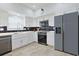Modern kitchen with white cabinets, stainless steel appliances, an island, and stylish countertops at 867 Cardinal Pl., North Myrtle Beach, SC 29582