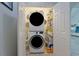 Convenient laundry area with stacked washer and dryer unit and shelving for storage at 867 Cardinal Pl., North Myrtle Beach, SC 29582