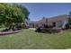 Expansive backyard featuring a stone patio and lush green lawn, perfect for outdoor entertaining and relaxation at 901 Southwind Ct., Garden City Beach, SC 29576