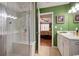 Bathroom features a glass enclosed shower with a tiled bench, and a door to the Primary bedroom at 901 Southwind Ct., Garden City Beach, SC 29576
