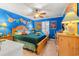 bedroom with teal accent wall, wooden furniture, ceiling fan and ample natural light at 901 Southwind Ct., Garden City Beach, SC 29576
