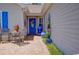 Inviting front porch with blue accents, garden decor, and seating area providing an intimate outdoor space at 901 Southwind Ct., Garden City Beach, SC 29576