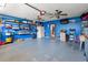 A spacious garage featuring blue walls, ceiling fans, and ample shelving for organization at 901 Southwind Ct., Garden City Beach, SC 29576