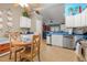 Bright open-concept kitchen featuring stainless steel appliances, white cabinetry, tile floors, and breakfast nook seating at 901 Southwind Ct., Garden City Beach, SC 29576