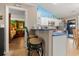 Bright kitchen with stainless steel appliances, white cabinets, breakfast bar with seating and a view of the main bedroom at 901 Southwind Ct., Garden City Beach, SC 29576