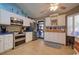Modern kitchen with stainless steel appliances, white cabinets, granite countertops, and a breakfast nook with seating at 901 Southwind Ct., Garden City Beach, SC 29576