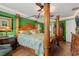Spacious main bedroom boasts a decorative wood bed frame, and green accent wall at 901 Southwind Ct., Garden City Beach, SC 29576