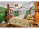 Well-lit main bedroom showcases wood-frame bed with overhead fan and a large window for natural light at 901 Southwind Ct., Garden City Beach, SC 29576
