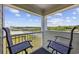 Balcony view of lake and landscape, with chairs, providing a serene outdoor living space at 9400 Shore Dr. # 509, Myrtle Beach, SC 29572