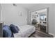 Comfortable bedroom showcasing an open layout to living room, with nautical-themed decor and hardwood floors at 9400 Shore Dr. # 509, Myrtle Beach, SC 29572