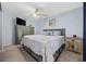 Cozy bedroom with a wooden headboard, soft lighting from a ceiling fan, and tasteful nautical decor at 9400 Shore Dr. # 509, Myrtle Beach, SC 29572