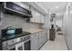 Updated kitchen with stainless steel appliances, new countertops, tiled backsplash and view to bedroom at 9400 Shore Dr. # 509, Myrtle Beach, SC 29572