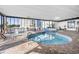 Indoor pool area with brick floor and large windows offering outdoor views at 9400 Shore Dr. # 509, Myrtle Beach, SC 29572