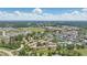 Picturesque aerial view of a vibrant community with townhomes, pool, and tennis courts amidst lush green spaces and a distant skyline at 951 Plantation Dr. # F8, Little River, SC 29566