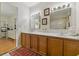 Bathroom featuring a double vanity, decorative wallpaper and neutral flooring at 951 Plantation Dr. # F8, Little River, SC 29566