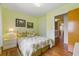 Bedroom with light green walls and tropical-themed bedding at 951 Plantation Dr. # F8, Little River, SC 29566