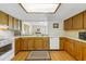 Efficient kitchen offering bright countertops and classic wood cabinetry at 951 Plantation Dr. # F8, Little River, SC 29566