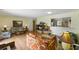Cozy living area with wood-look floors, an open layout, and a pass-through window to the kitchen at 951 Plantation Dr. # F8, Little River, SC 29566