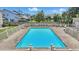 A refreshing community pool area enclosed by a fence, perfect for relaxation and recreation with seating and well-maintained surroundings at 951 Plantation Dr. # F8, Little River, SC 29566