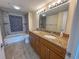 Modern bathroom features dual sinks, granite countertops, and a tiled shower at 9840 Queensway Blvd. # 329, Myrtle Beach, SC 29572