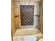 Bright bathroom tub and shower area features attractive tile work and useful shelving at 9840 Queensway Blvd. # 329, Myrtle Beach, SC 29572